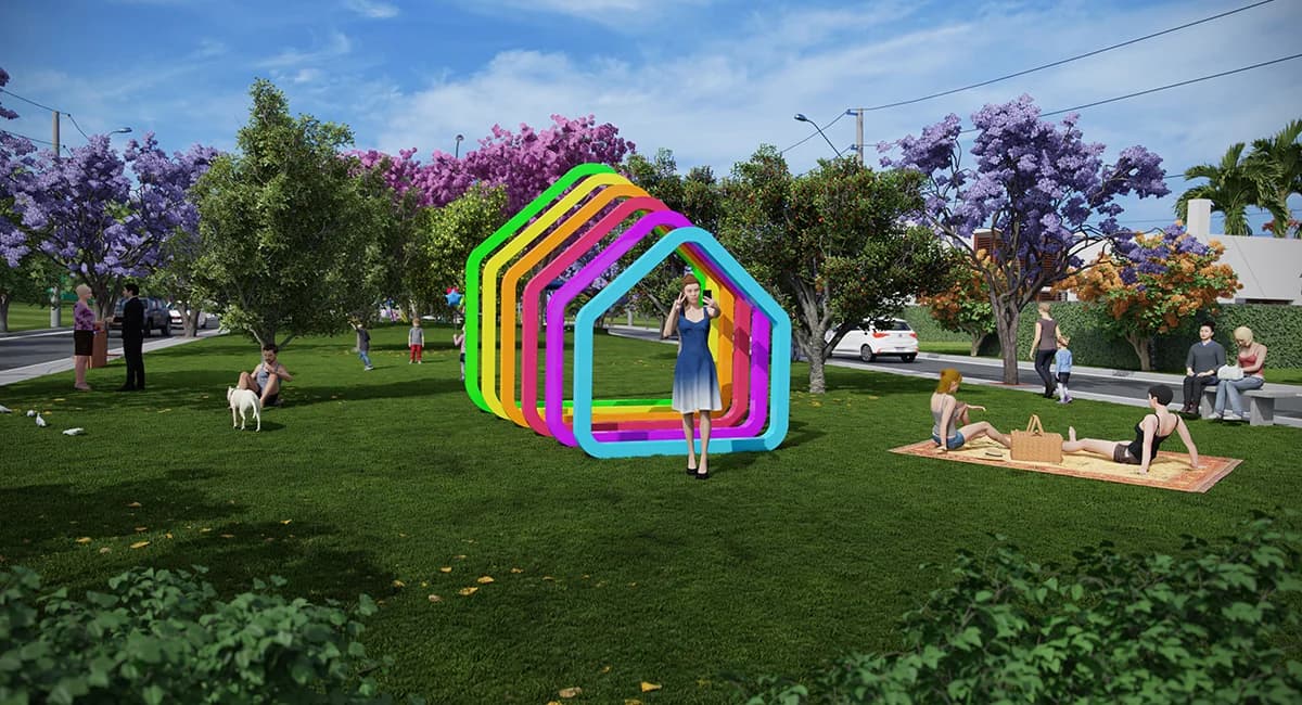 Praça gramada com escultura colorida e famílias fazendo piquenique